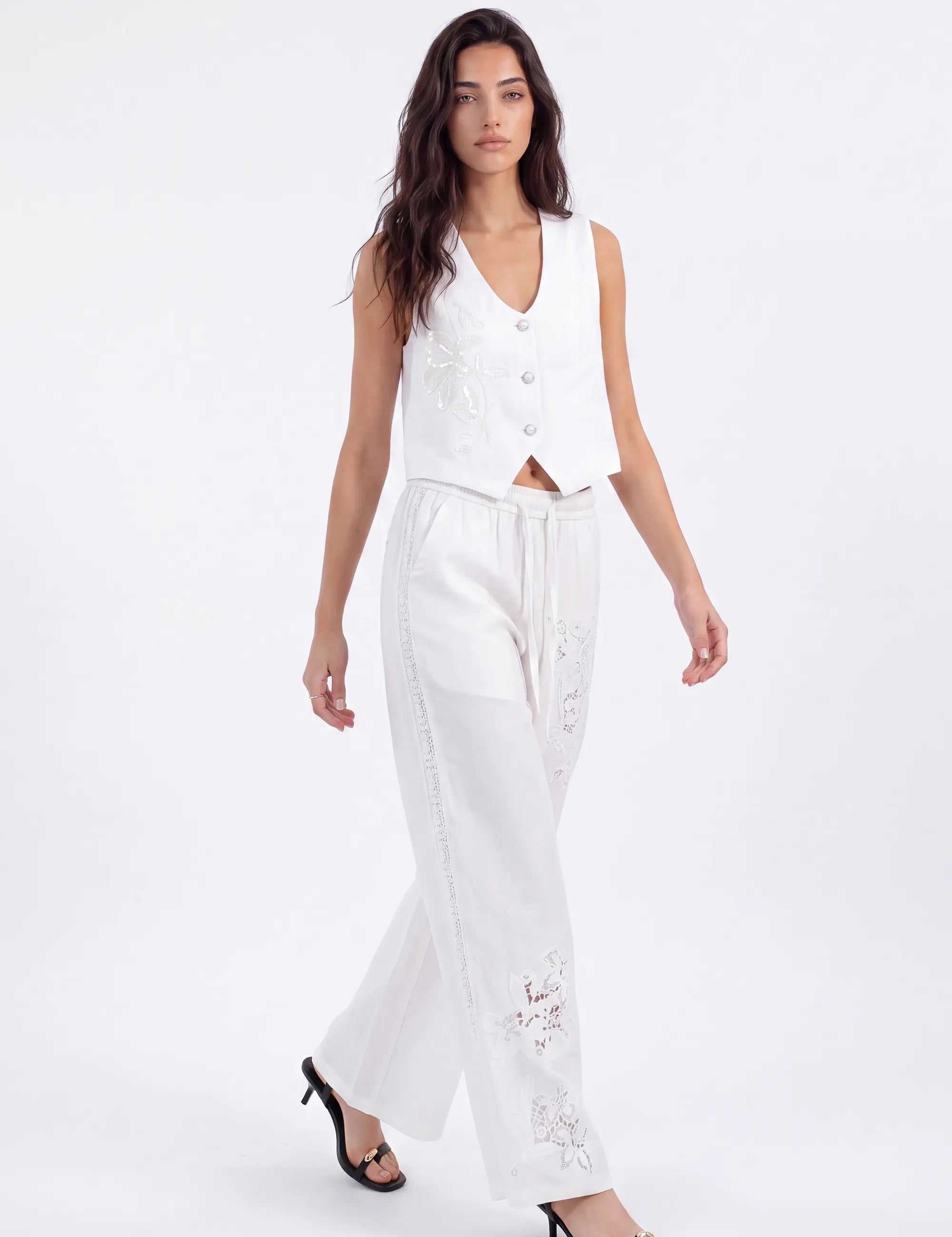 White Cropped Vest with Floral Cutwork Embroidery and Pearl Buttons on model, studio view 2 – Elppis 1B5D07501WW-01CM
