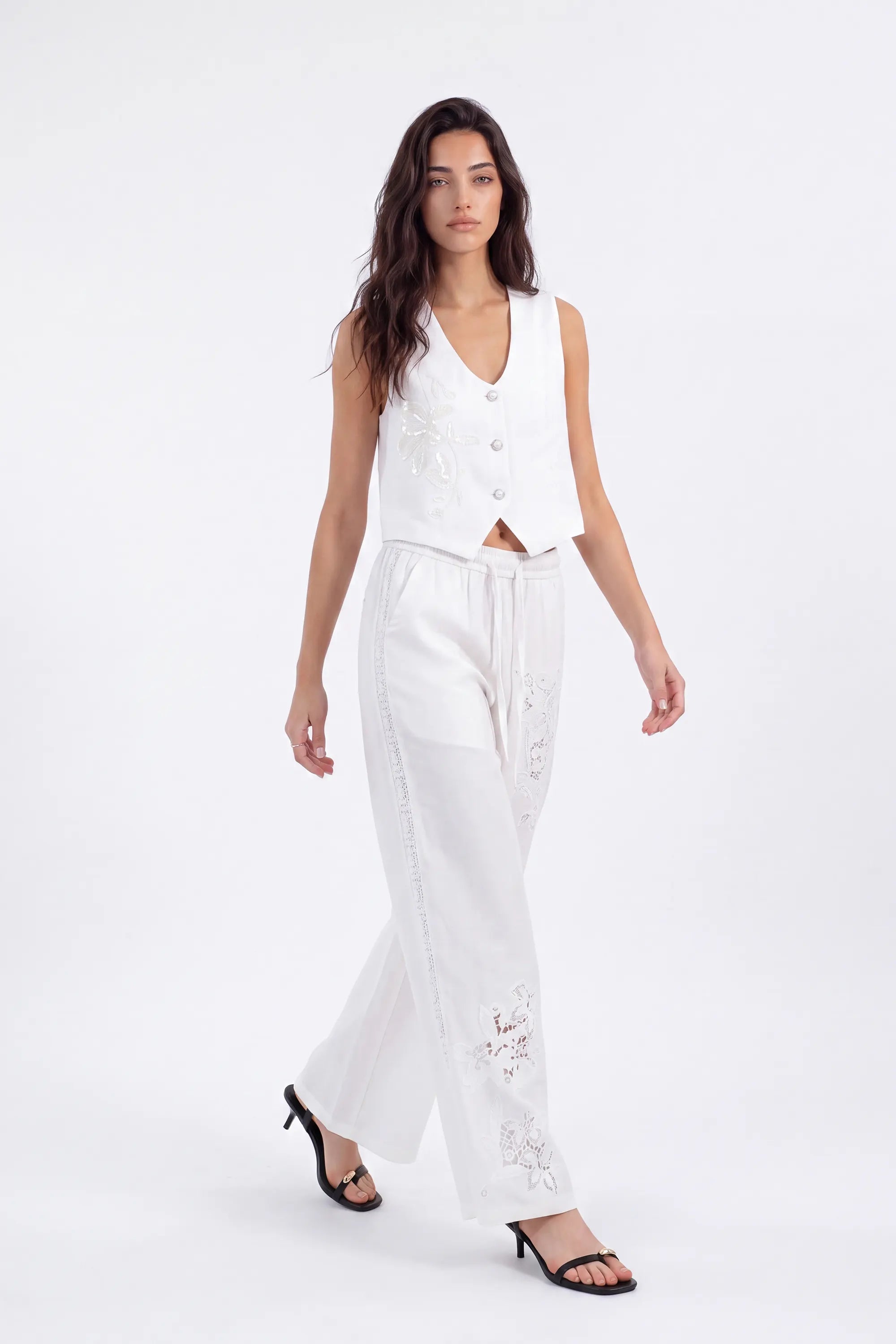White Cropped Vest with Floral Cutwork Embroidery and Pearl Buttons on model, studio view 2 – Elppis 1B5D07501WW-01CM