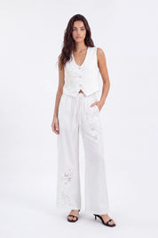 White Cropped Vest with Floral Cutwork Embroidery and Pearl Buttons on model, studio view 3 – Elppis 1B5D07501WW-01CM