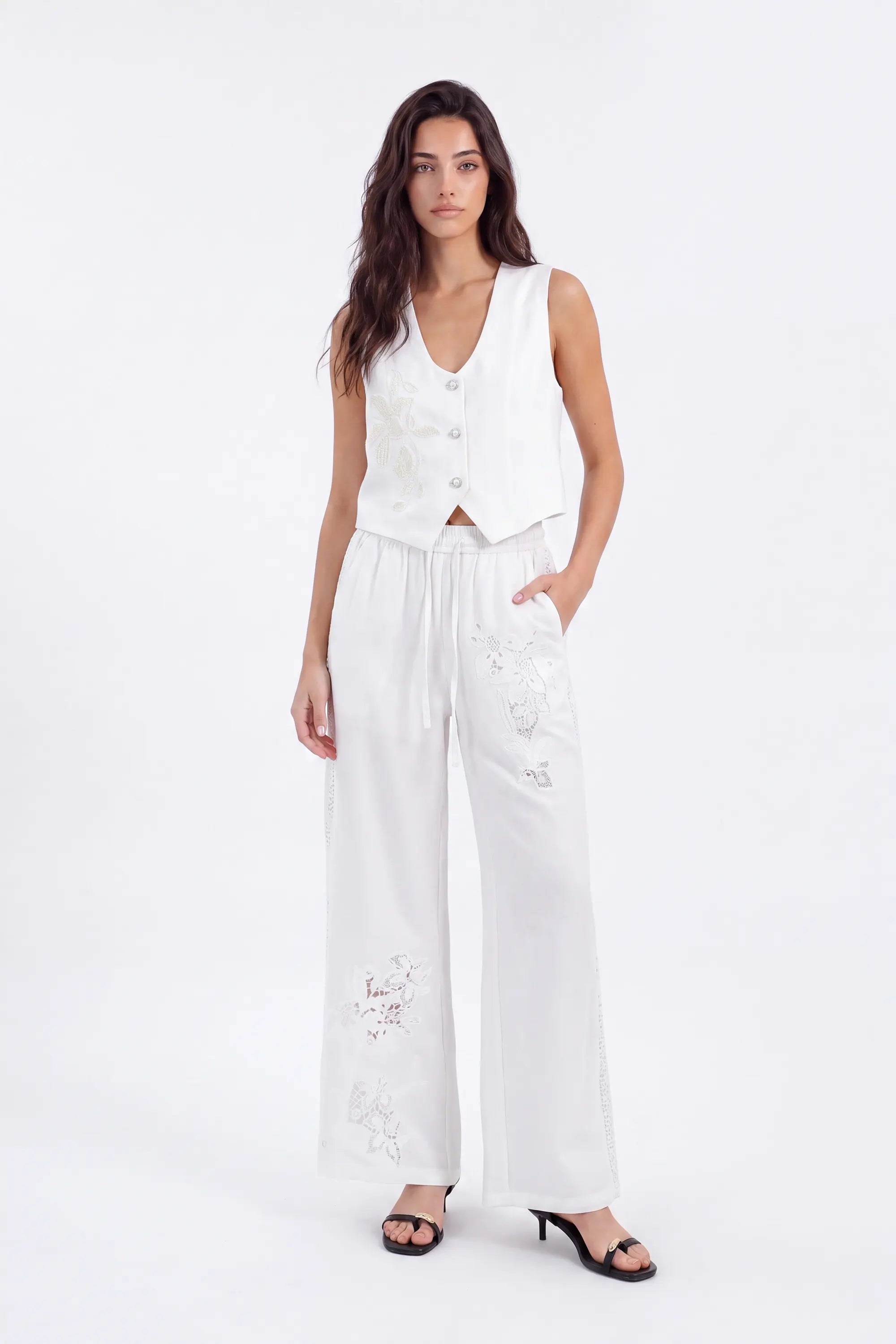 White Cropped Vest with Floral Cutwork Embroidery and Pearl Buttons on model, studio view 3 – Elppis 1B5D07501WW-01CM