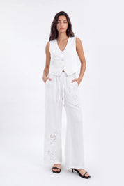 White Cropped Vest with Floral Cutwork Embroidery and Pearl Buttons on model, studio view 4 – Elppis 1B5D07501WW-01CM