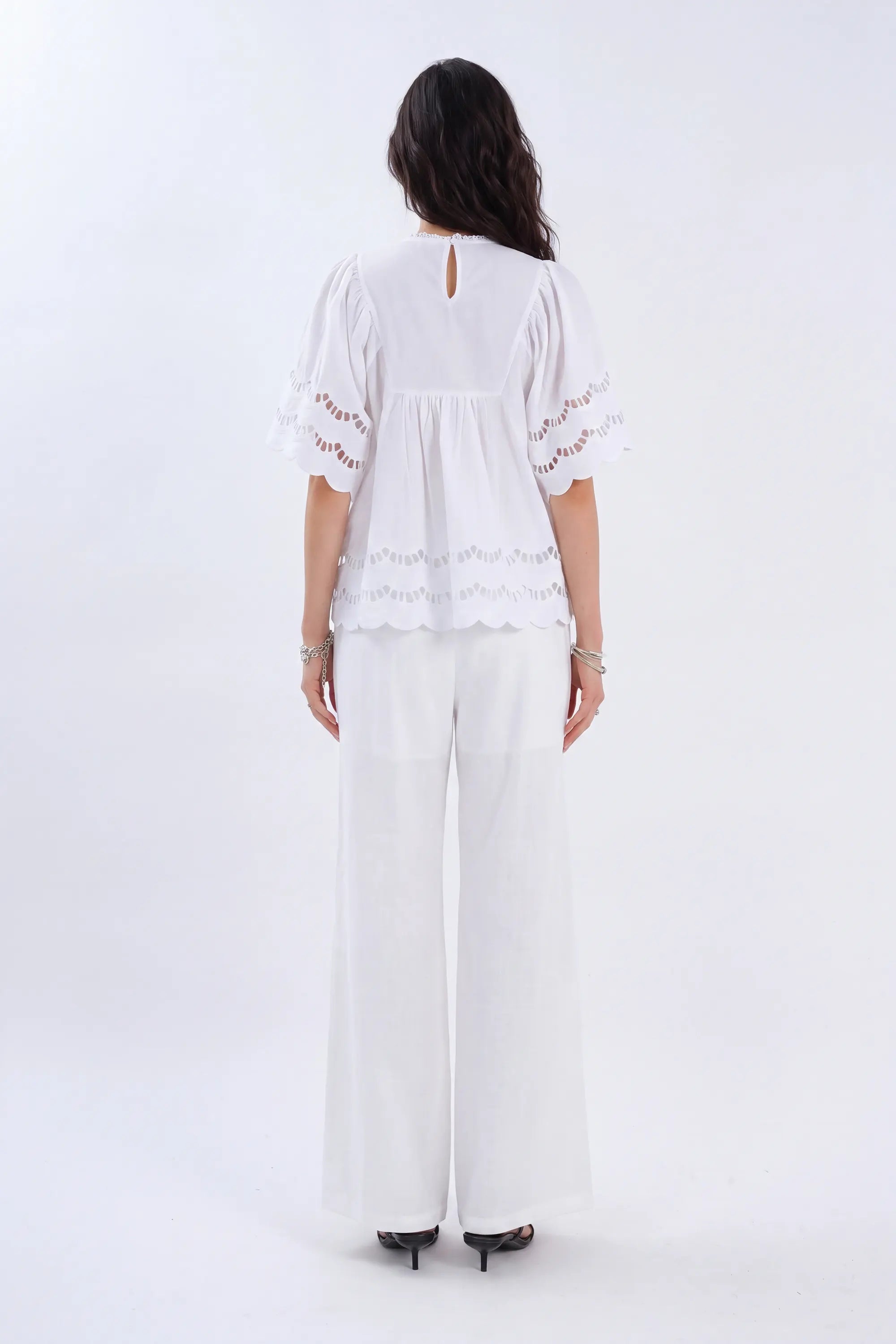 White Short-Sleeve Blouse with Cutwork Embroidery and Ruffled Hem on model, back view – Elppis 1B5E09174WW-01CM