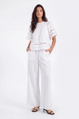 White Short-Sleeve Blouse with Cutwork Embroidery and Ruffled Hem