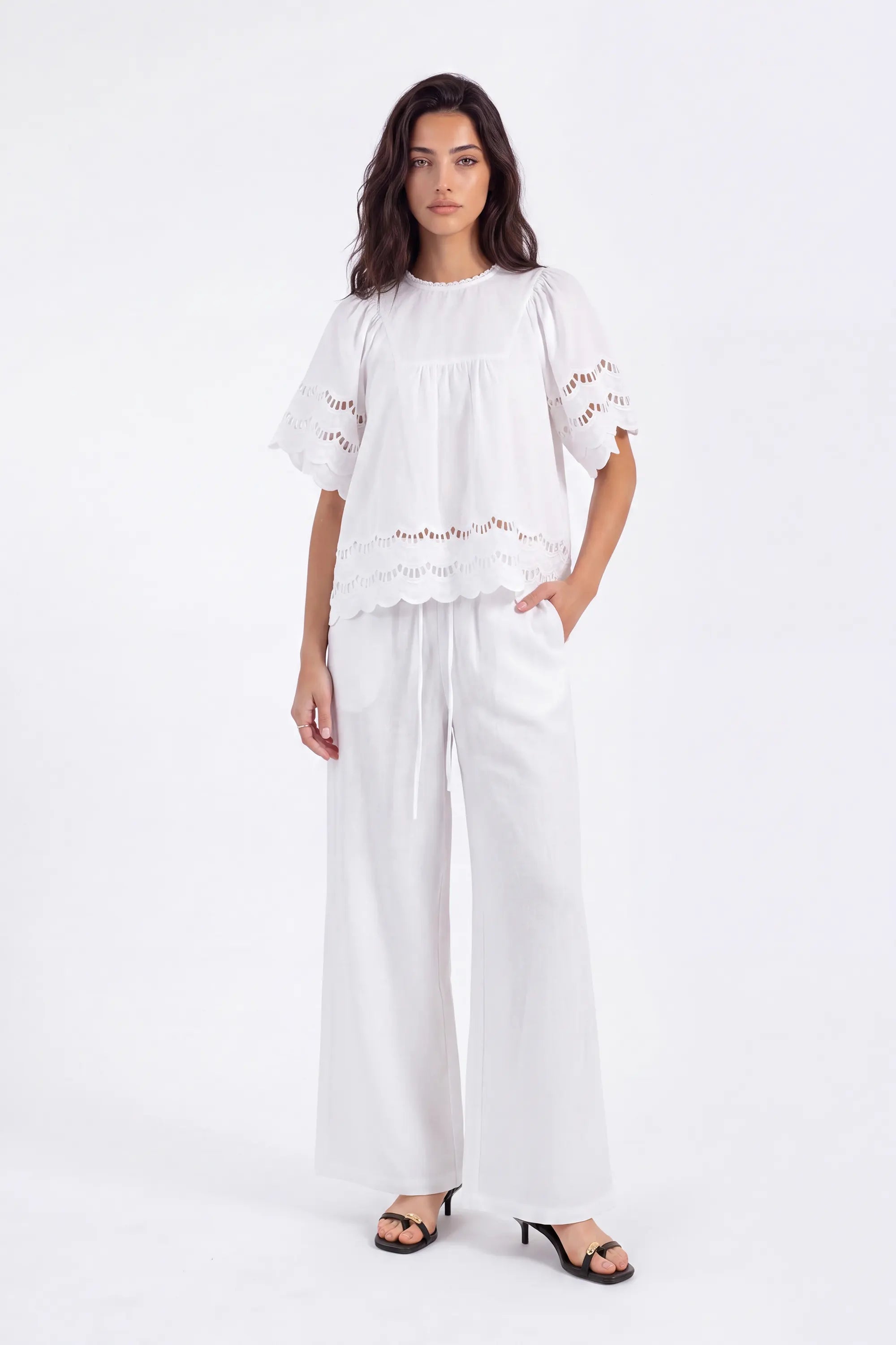 White Short-Sleeve Blouse with Cutwork Embroidery and Ruffled Hem on model, studio view 4 – Elppis 1B5E09174WW-01CM