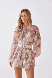 Elppis blush pink romantic rose print chiffon blouse on a model against a white background