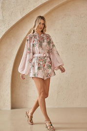 Elppis blush pink rose print chiffon blouse styled in an arched studio