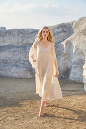 Full-length model view of the Elppis blush pink sheer midi slip dress