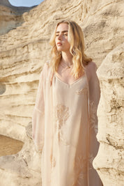 Close-up of the thin straps and neckline on the blush pink midi slip dress