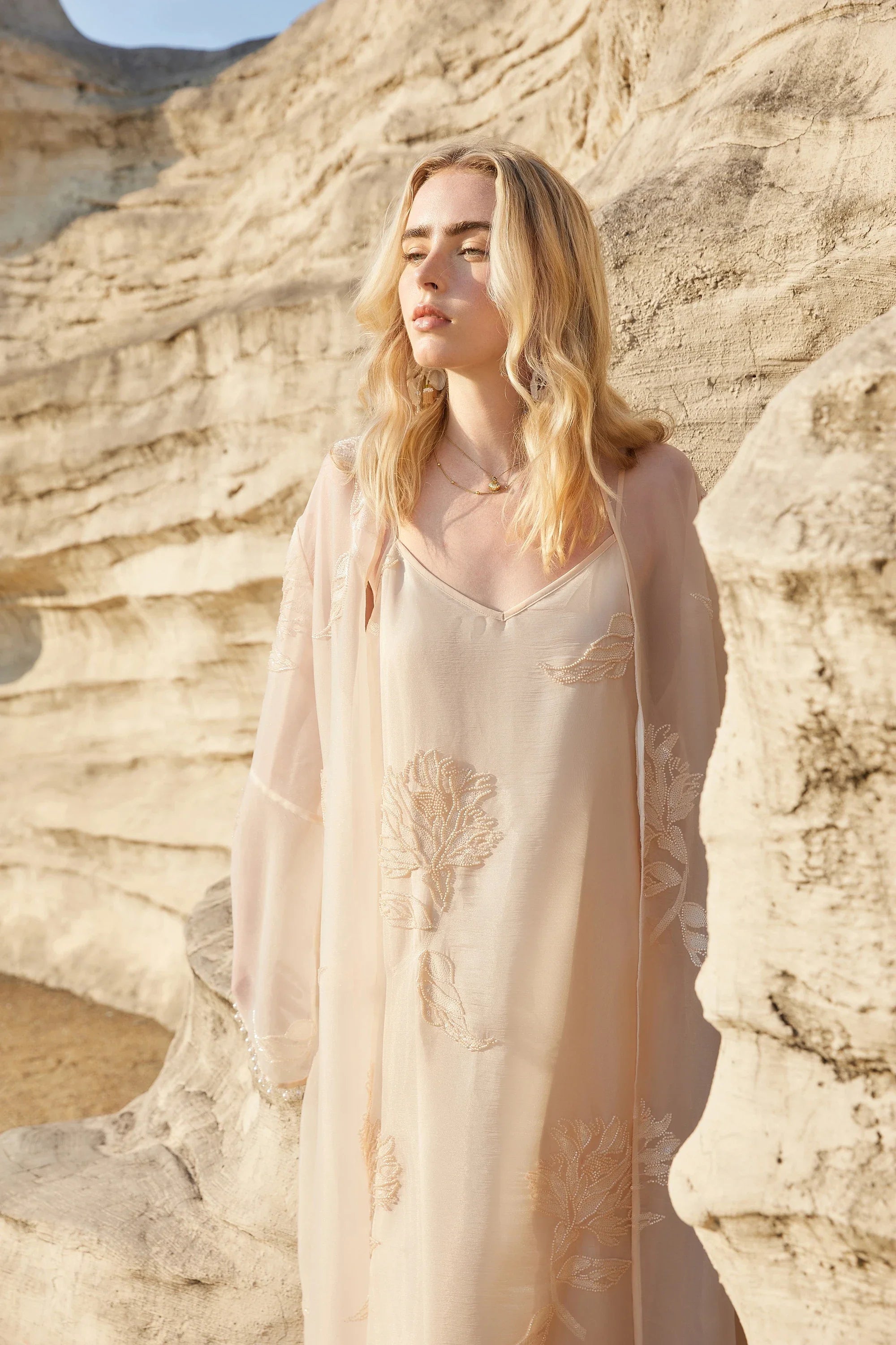 Close-up of the thin straps and neckline on the blush pink midi slip dress