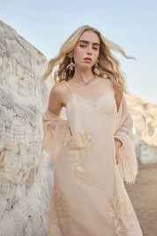 Front outdoor view of the Elppis blush pink embroidered midi slip dress