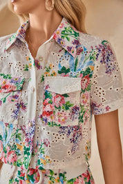 Close-up of the collar and front pockets on the floral eyelet cropped shirt
