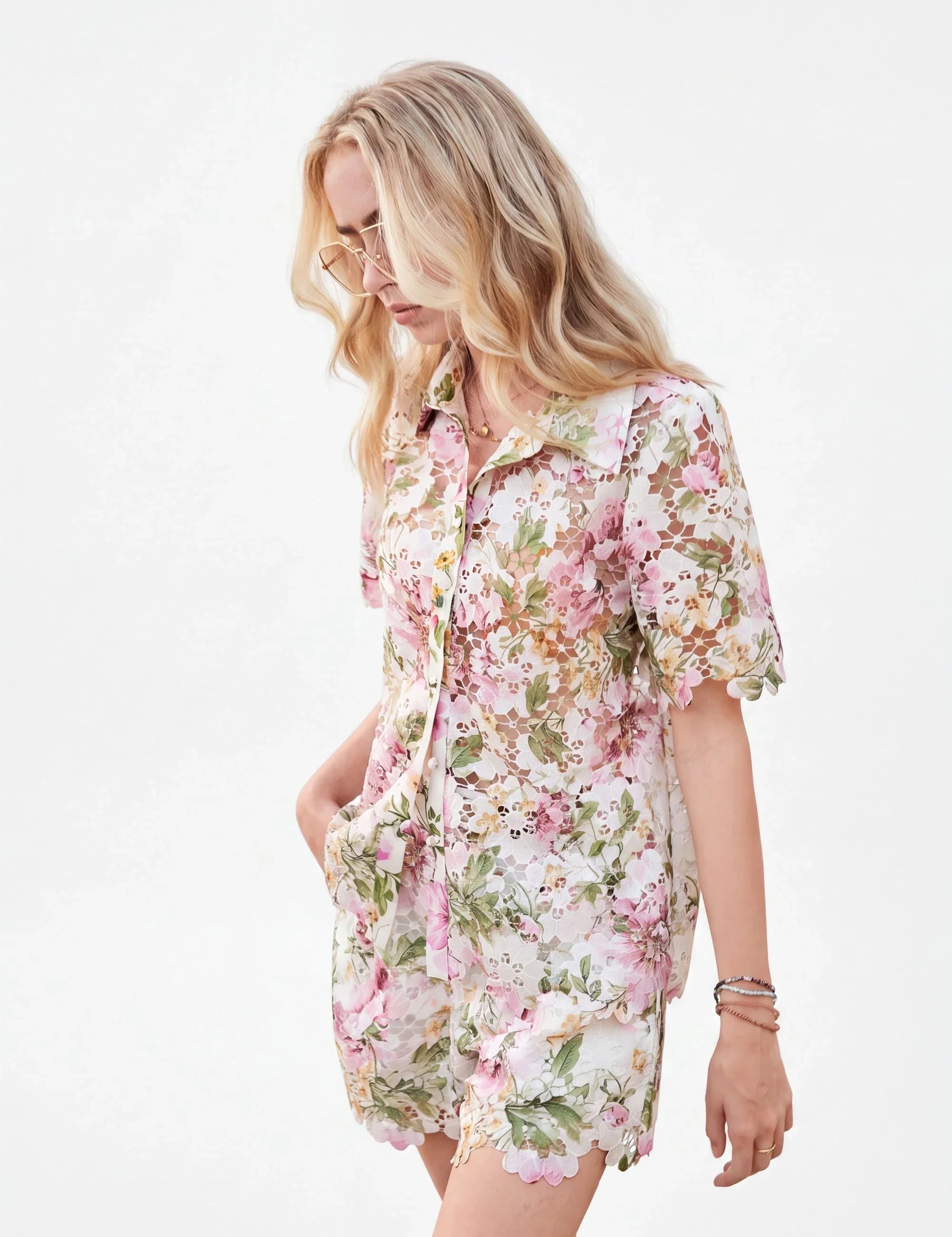 Elppis floral eyelet lace high-waisted shorts on a model against a white background