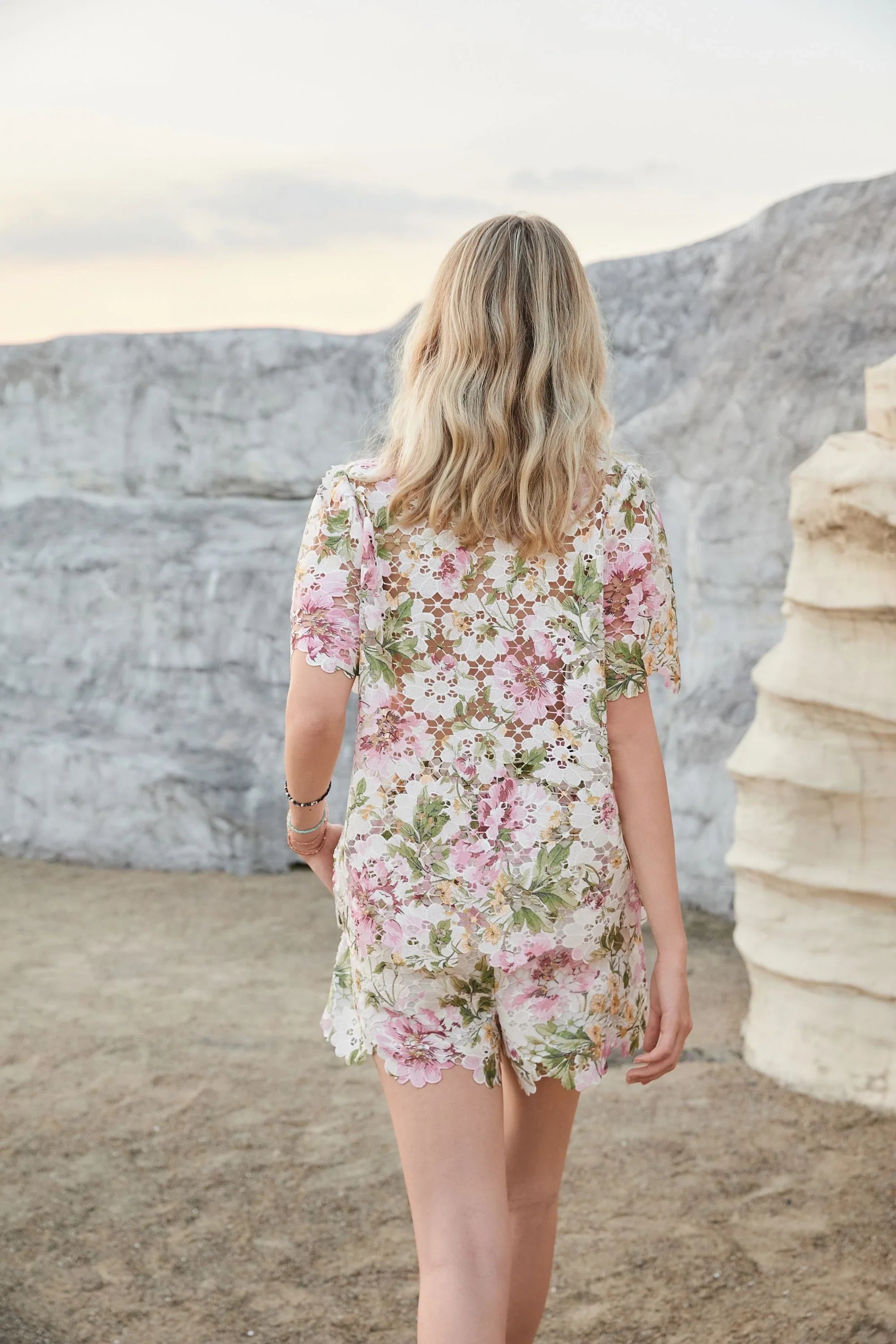 Back view of Elppis floral eyelet lace high-waisted shorts