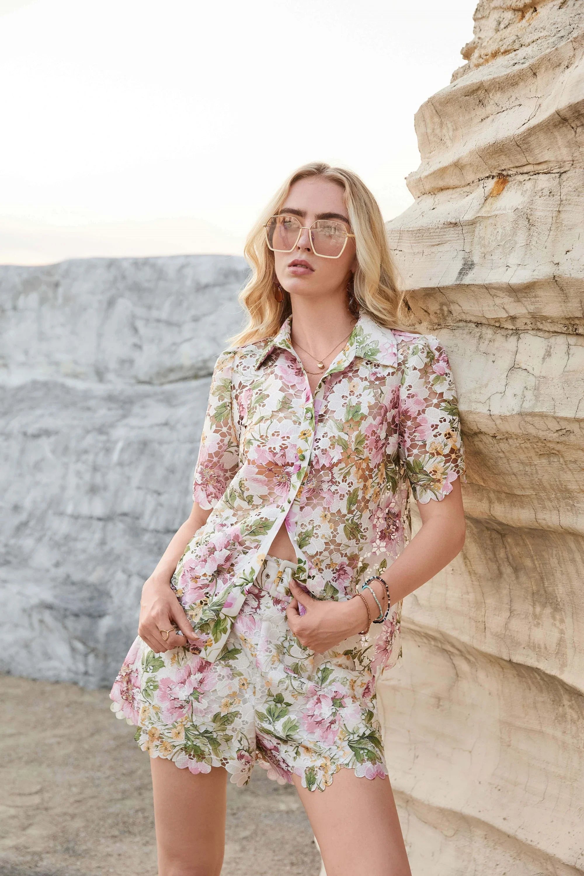 Front outdoor view of Elppis floral eyelet lace high-waisted shorts