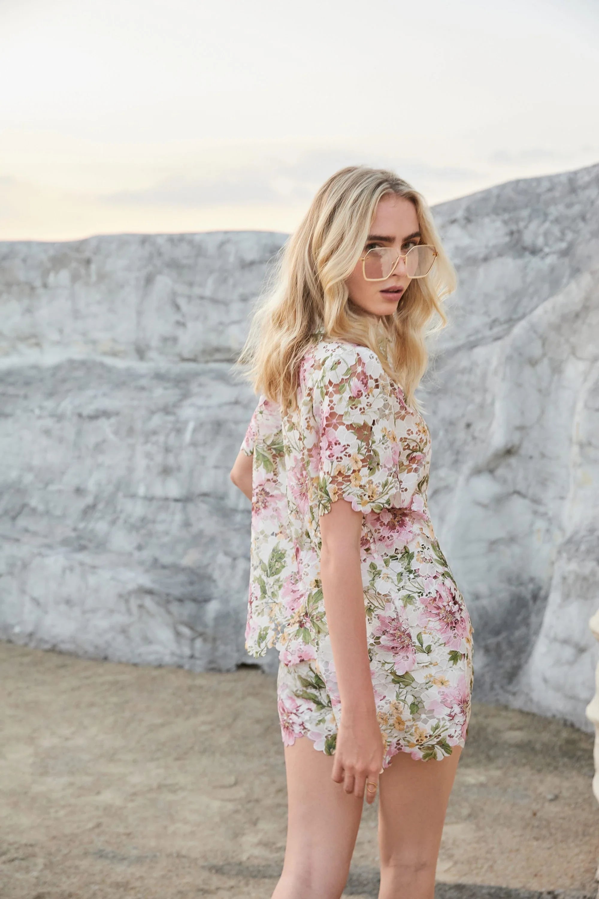 Elppis floral eyelet lace high-waisted shorts styled outdoors on a model