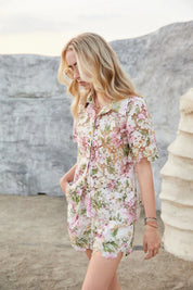 Side view of Elppis floral eyelet lace shorts on a model outdoors