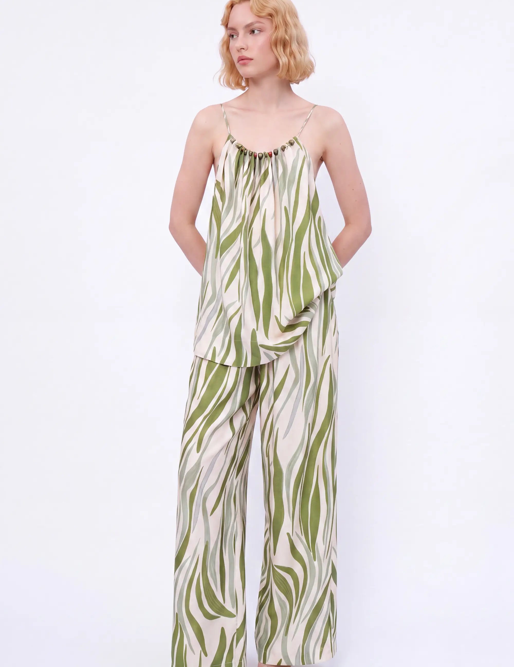 Elppis Green Abstract Stripe Beaded Halter Camisole modeled on a white background, relaxed front view