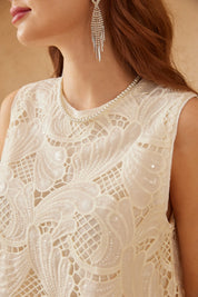 Close-up of the ivory floral lace sleeveless top neckline and embroidery