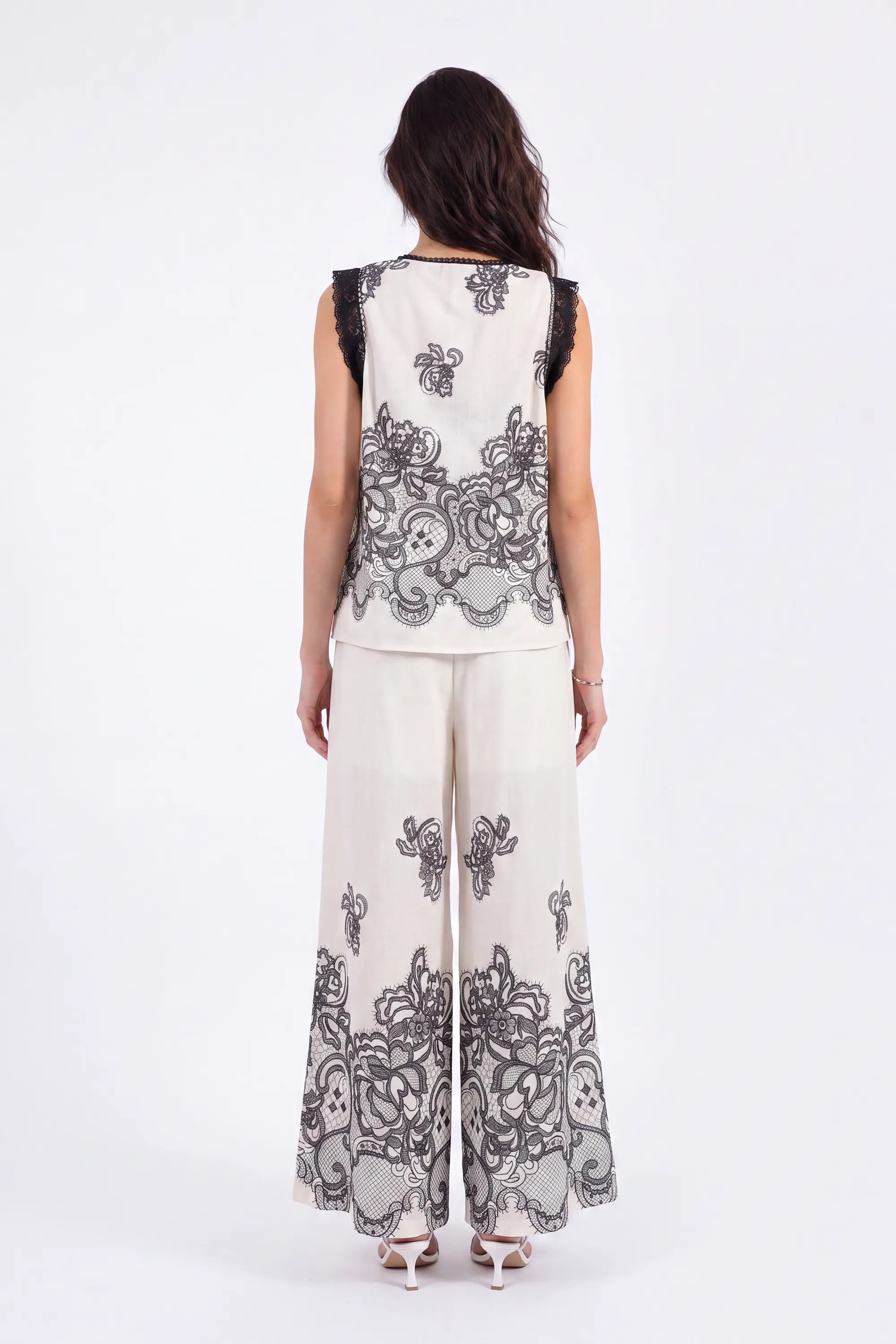 Ivory Wide-Leg Pants with Black Lace Floral Border Print on model, back view – Elppis JD4I7642BO