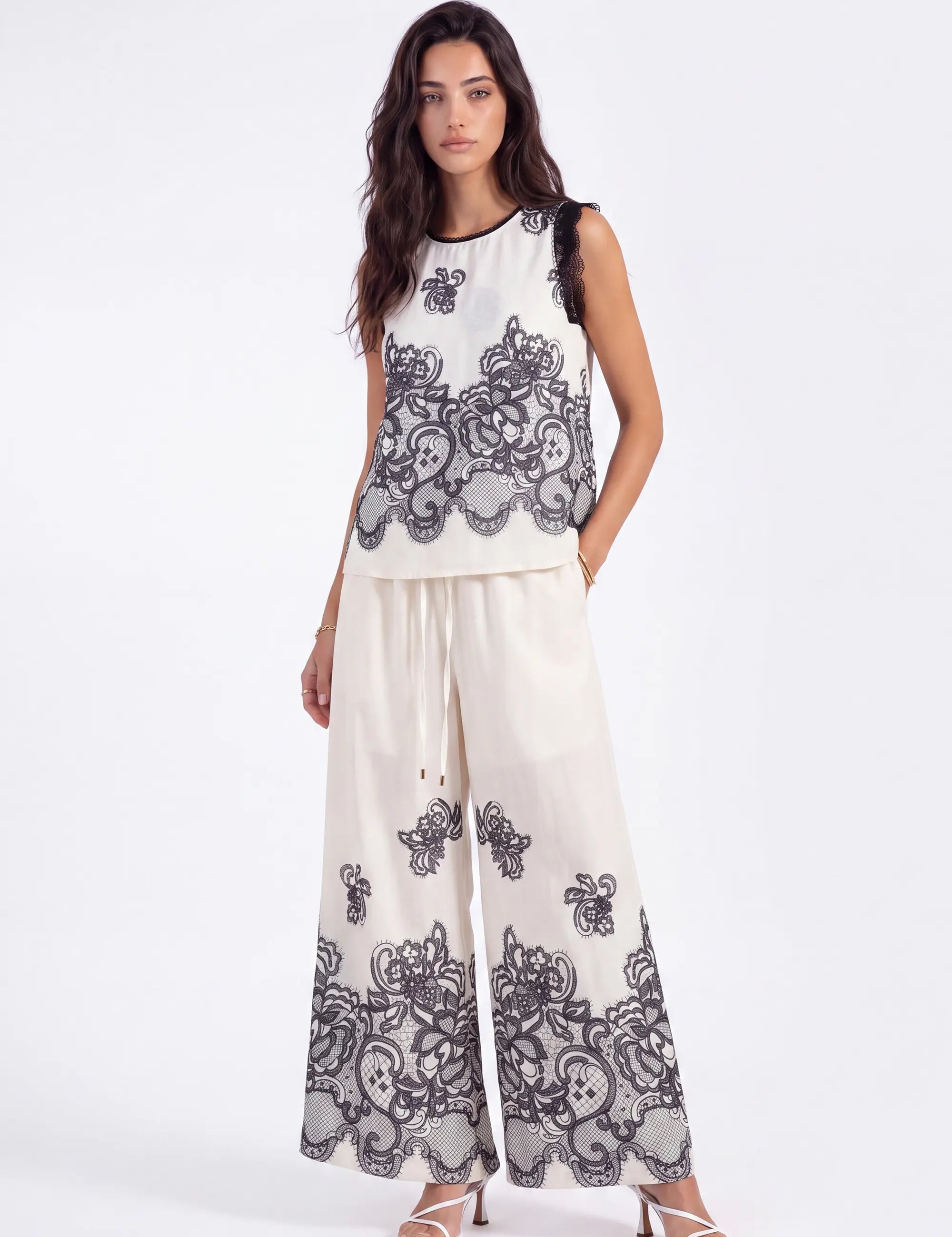 Ivory Wide-Leg Pants with Black Lace Floral Border Print on model, front view – Elppis JD4I7642BO