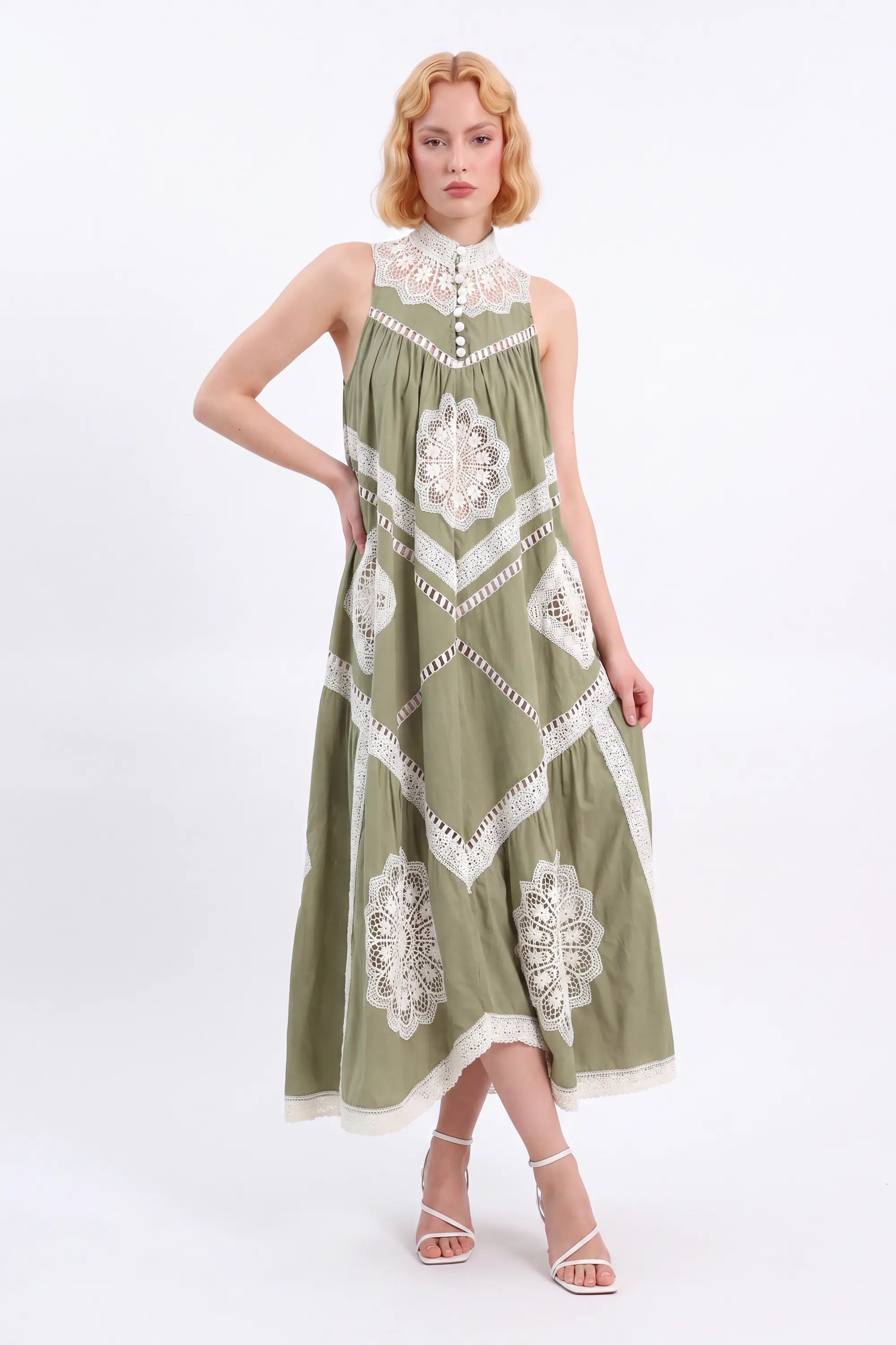 Olive green crochet lace sleeveless maxi dress by Elppis, angled model view on white background