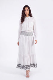 White Maxi Skirt with Black Geometric and Floral Embroidery on model, front view – Elppis UV3J9324F-1-F
