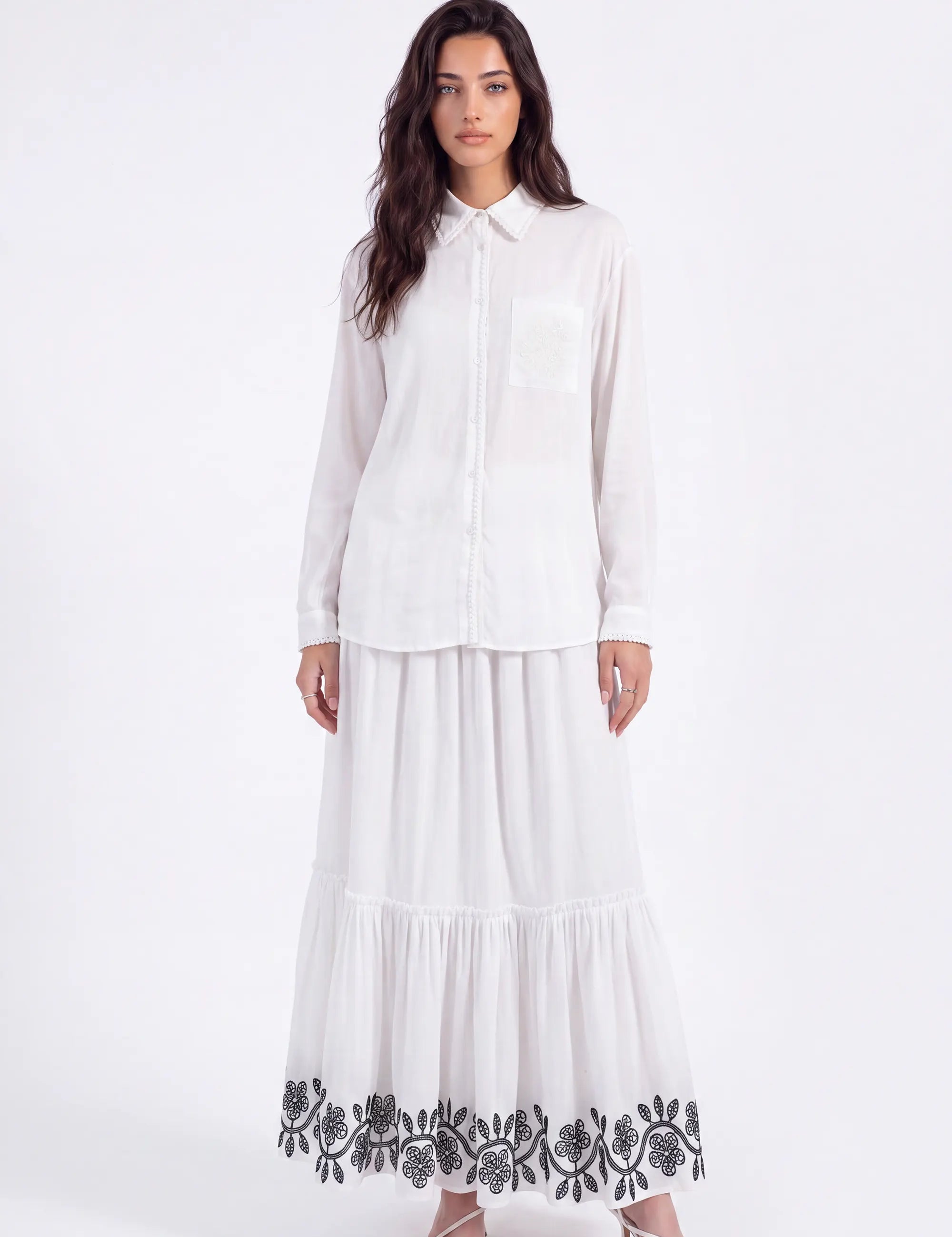 White Maxi Skirt with Black Geometric and Floral Embroidery on model, studio view 2 – Elppis UV3J9324F-1-F