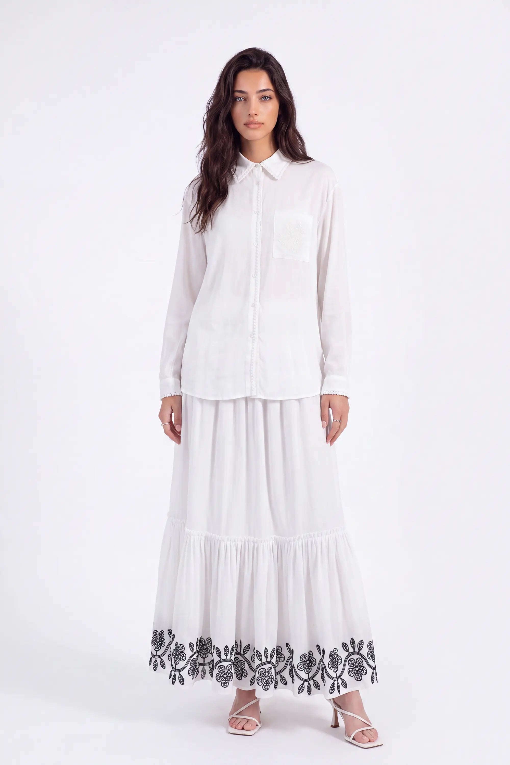 White Maxi Skirt with Black Geometric and Floral Embroidery on model, studio view 2 – Elppis UV3J9324F-1-F