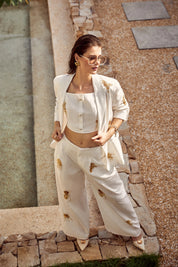 Elppis White Polyester Wide-Leg Pants with Gold Crane Embroidery, editorial styling view on model — SKU JD4I6657BO